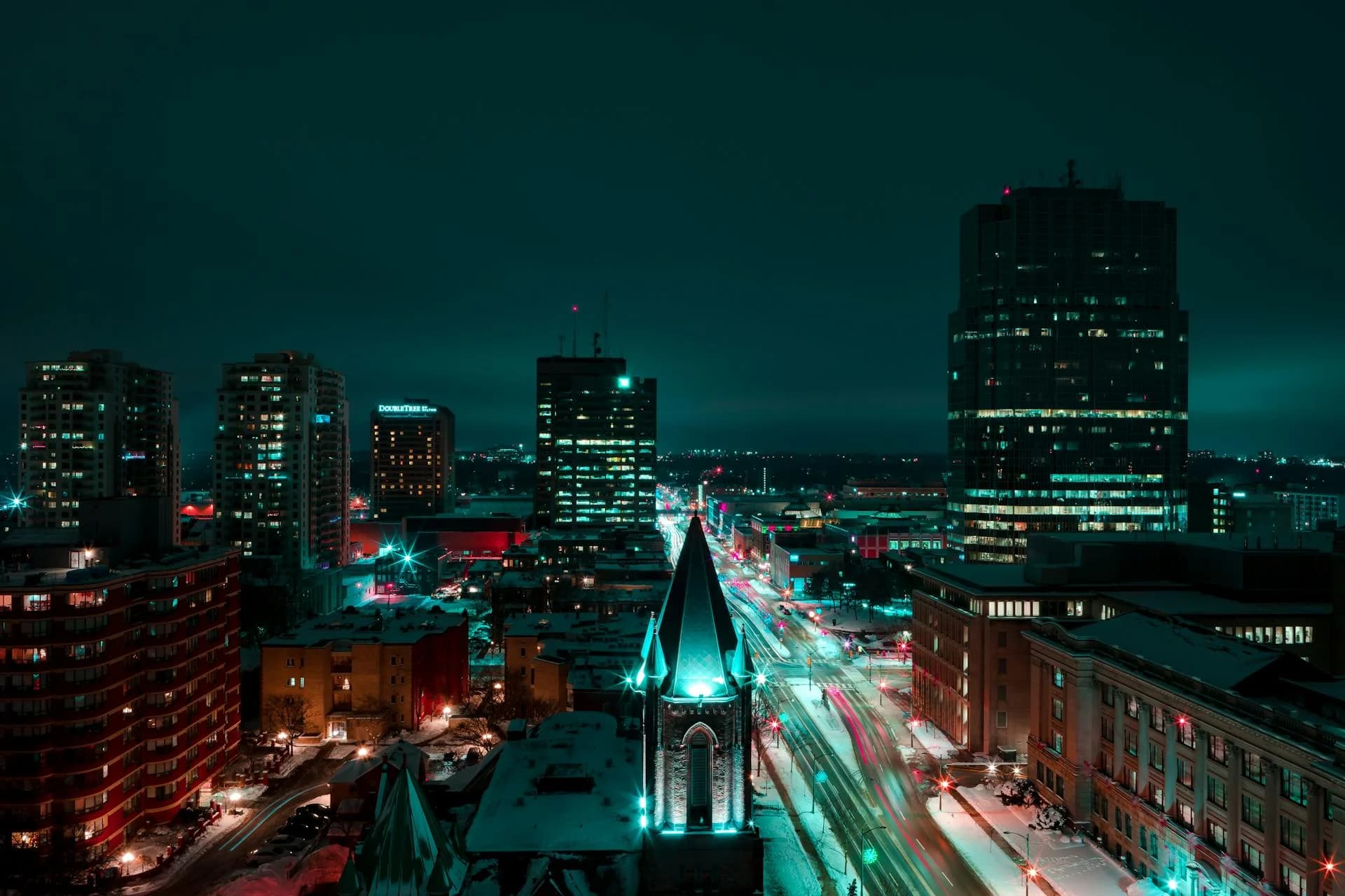 Aerial night view of downtown London Ontario with light trails